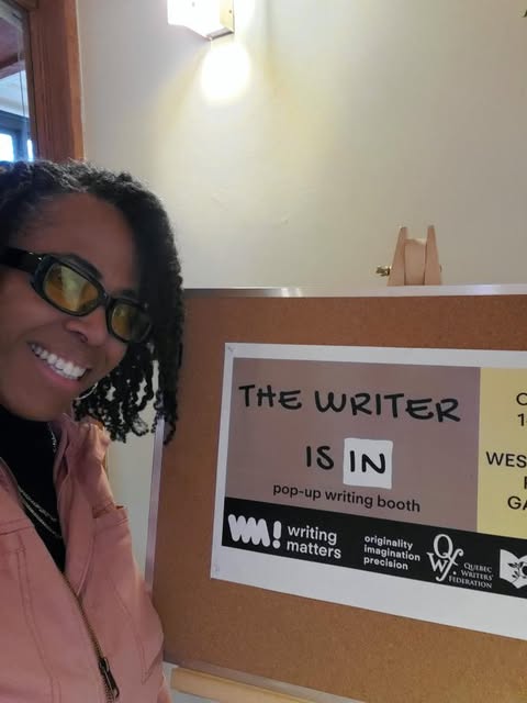 a picture of the poet stephanie roberts smiling next to a promotional The Writer is in sign.